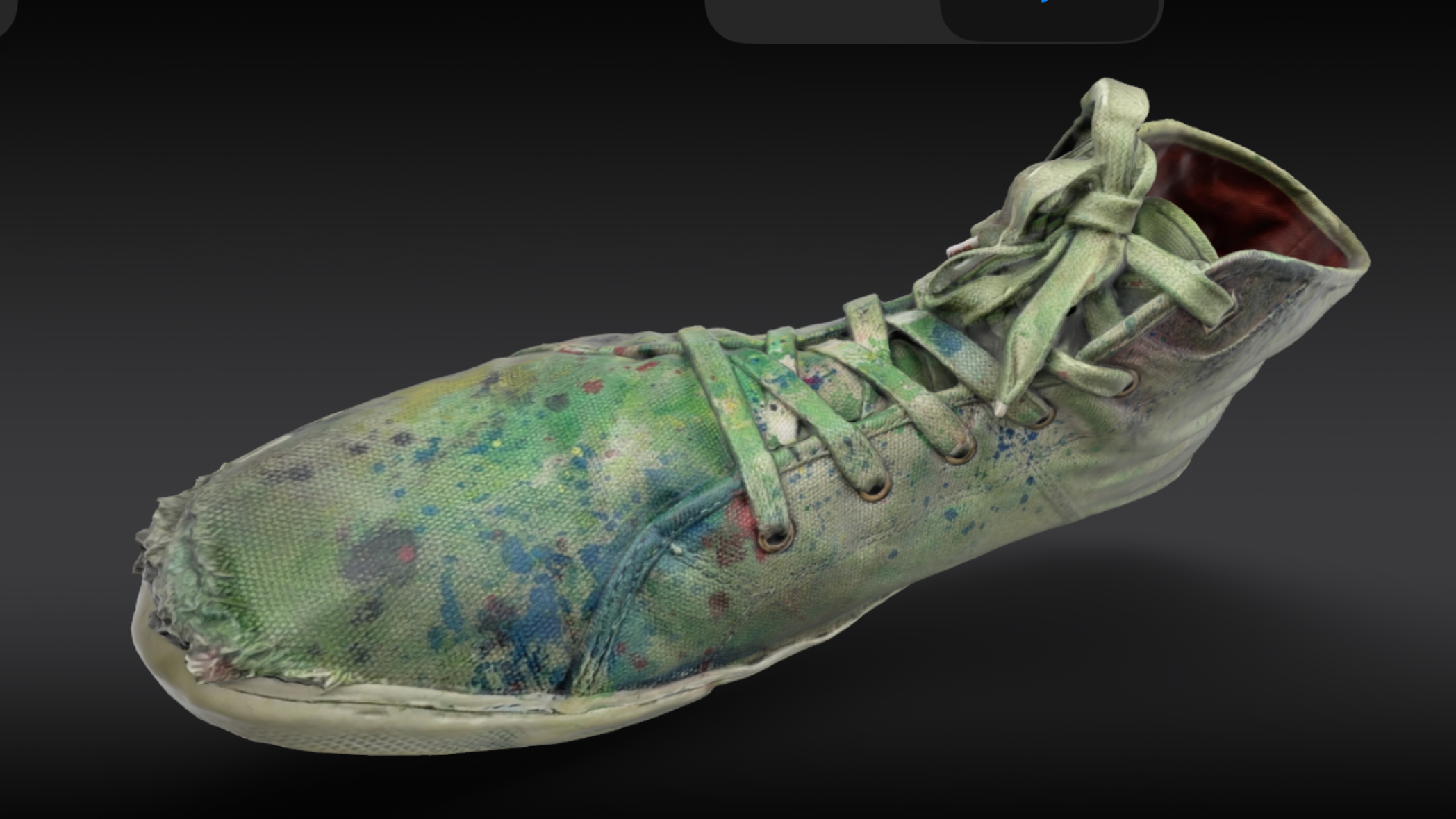 A photo of a still of a 3D image of a trainer, covered in paint.